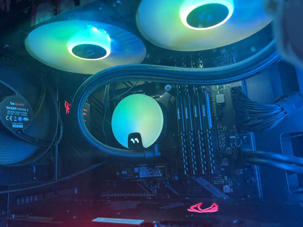 A closeup of the cooling unit in full swing, lighting up the inside of the case.