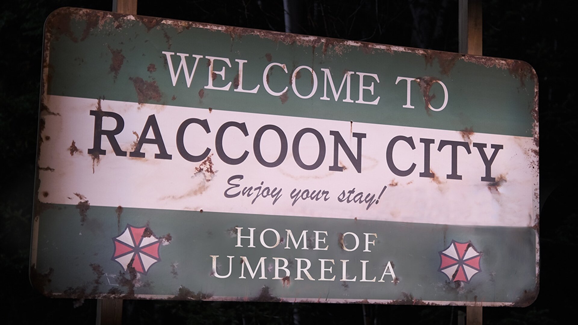 Sign that reads 'Welcome to Raccoon City, enjoy your Stay! Home of Umbrella Corp.'