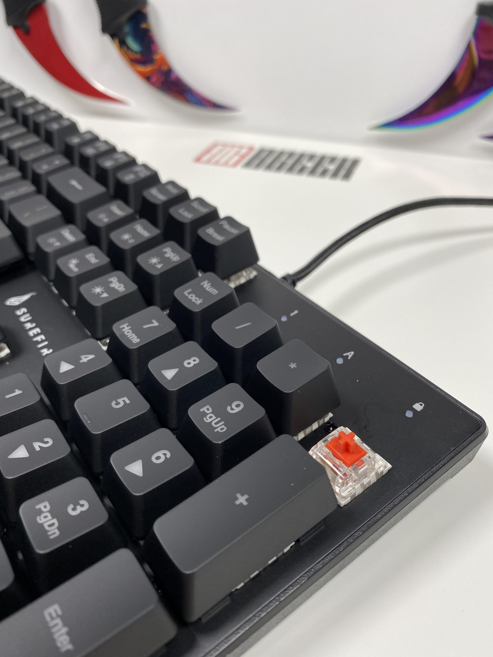 Removable keycaps for the SureFire Kingpin M2 with the red linear switch underneath.