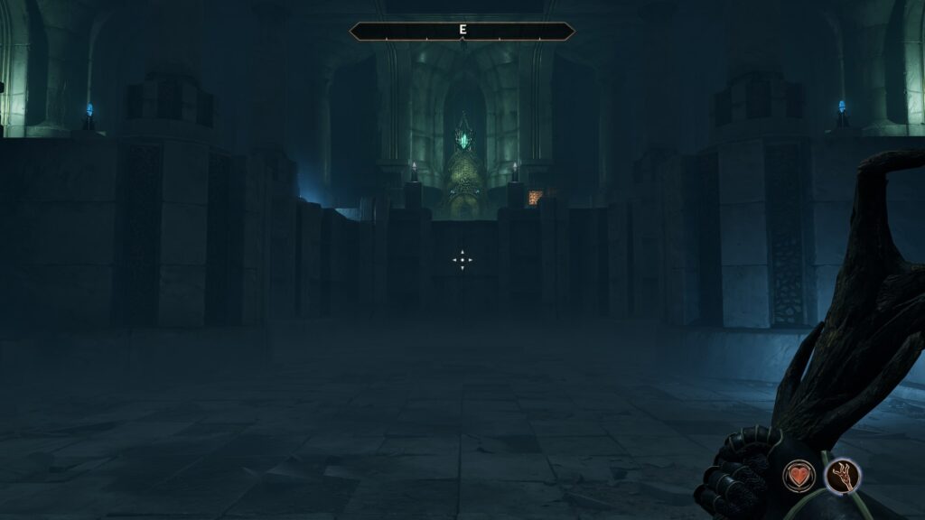 Inside a huge ayleid chamber, an ornate door alit by mysterious blue light in the distance.